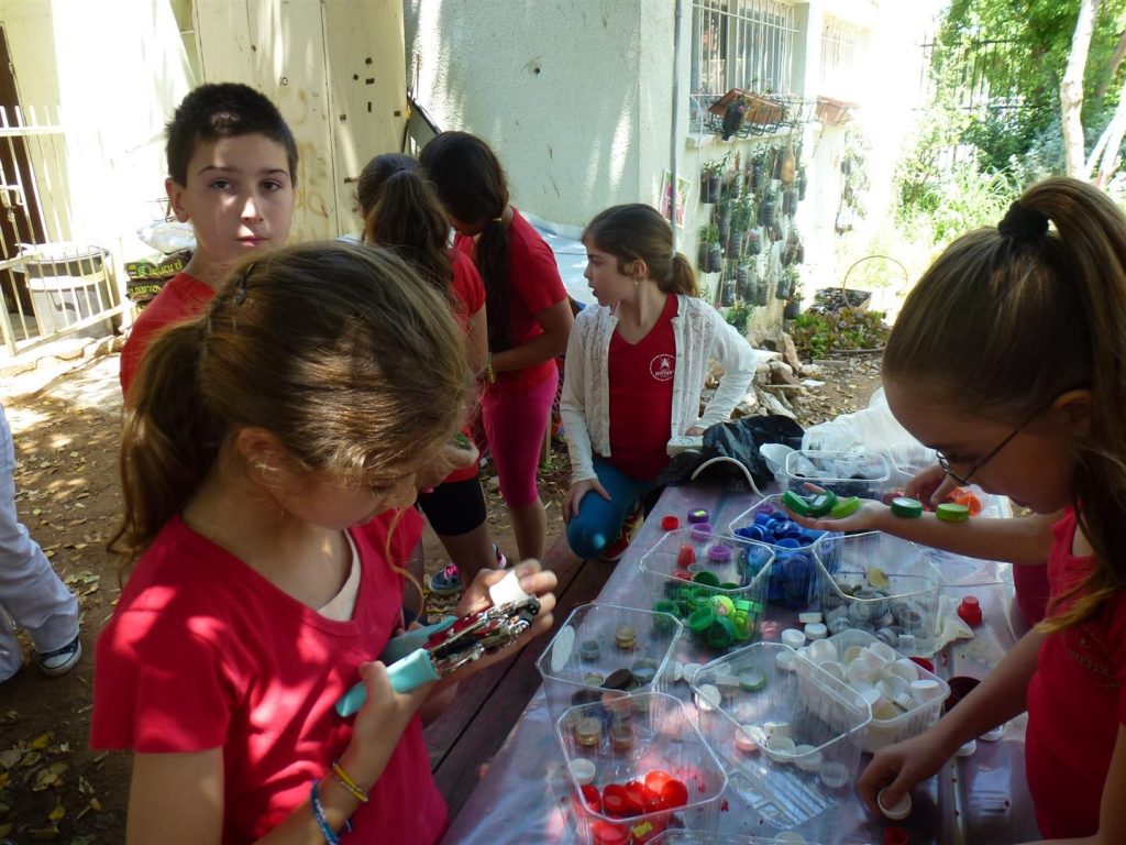 מיון פקקי פלסטיק ויצירת הכיתוב לשלט הפיסול