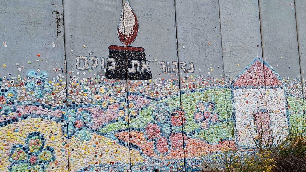 החומה הפנימי בנתיב העשרה מעוצבת באבני פסיפס וכתובת "נזכור את כולם"